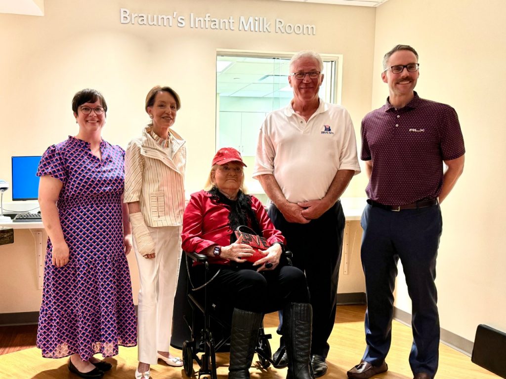 Five people standing in front of the Braum's Infant Milk Room 